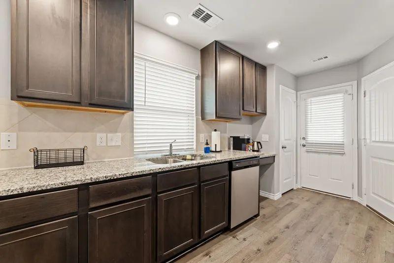 Kitchen sink, dishwasher and back door
