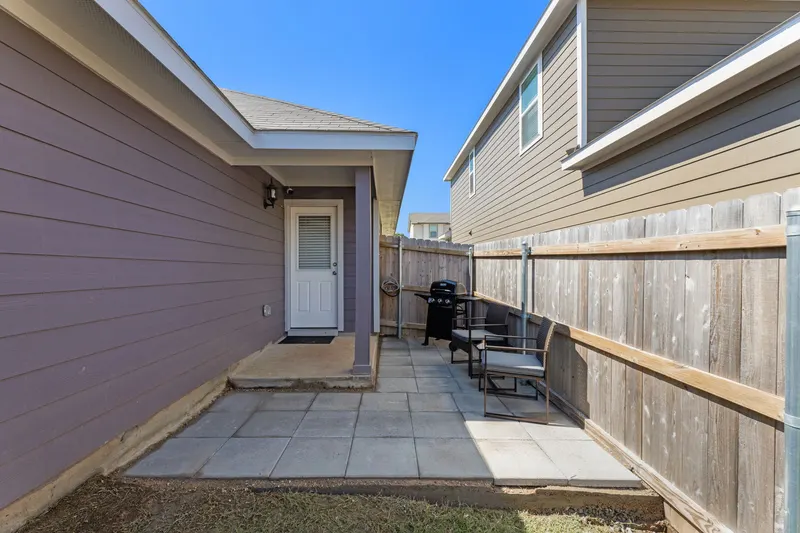 Back patio with seating and a grill
